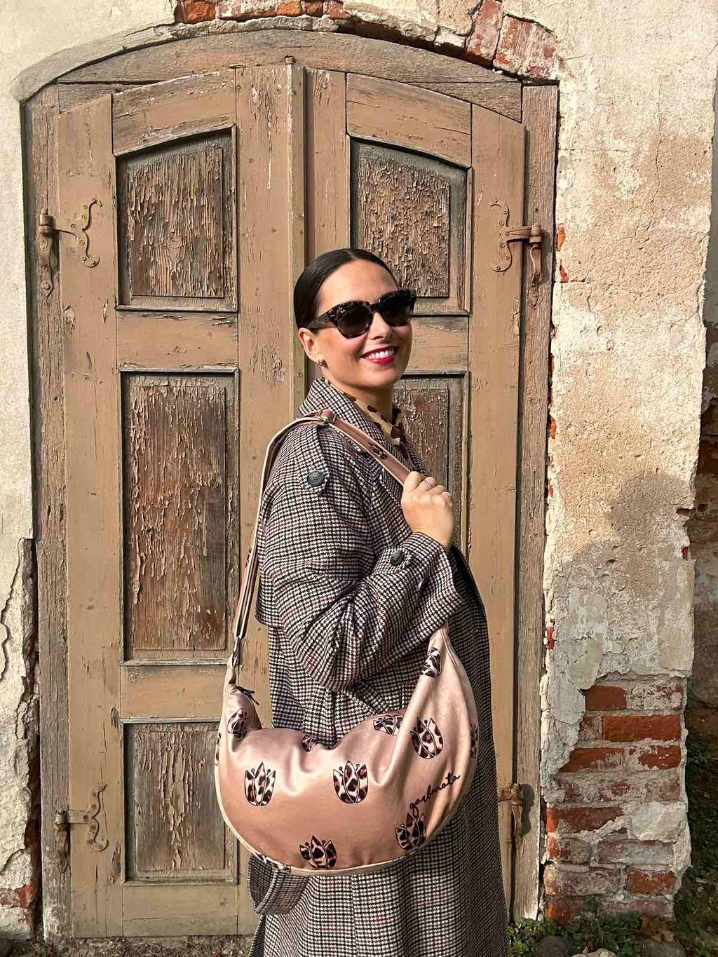 a soft brown leopard hobo bag with a comforting slouch, shown in warm morning light