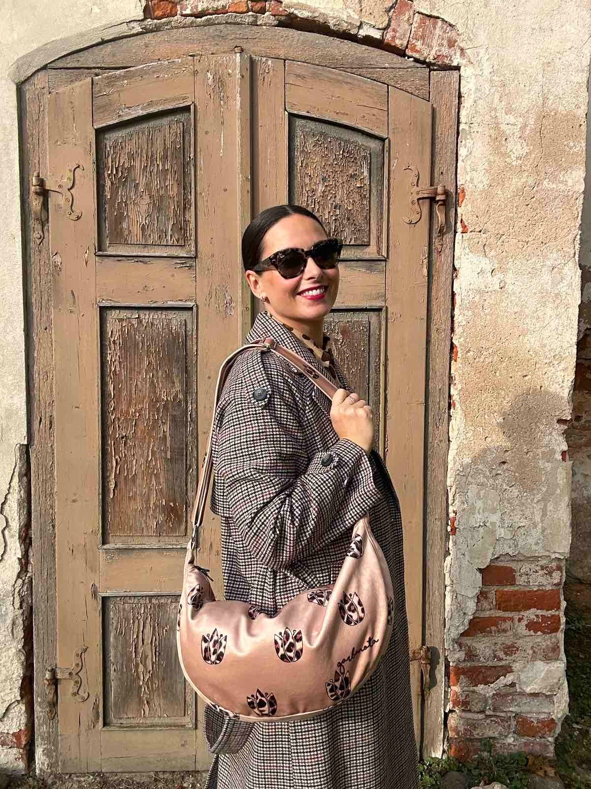 a soft brown leopard hobo bag with a comforting slouch, shown in warm morning light