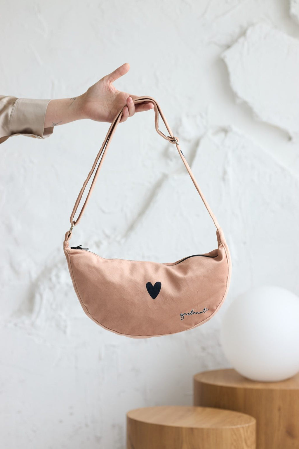 a soft cream velour hobo bag with a relaxed slouch, bathed in gentle morning light