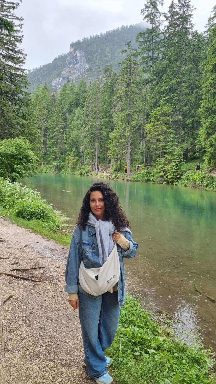 white velour hobo bag with heart charm, shown on a wooden table with morning light highlighting its soft texture