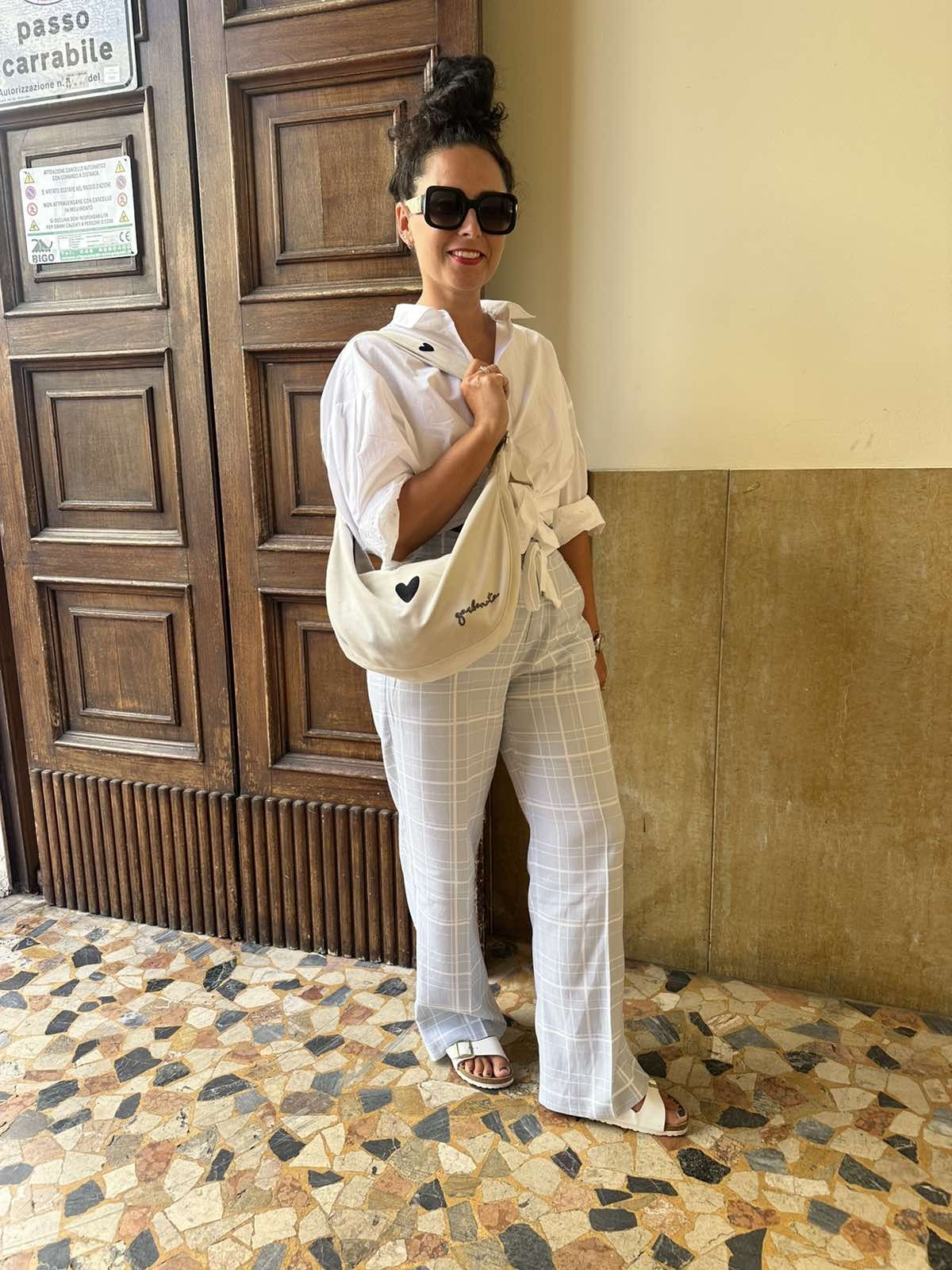 playful white velour hobo bag heart on a sunny park bench, strap playfully draped