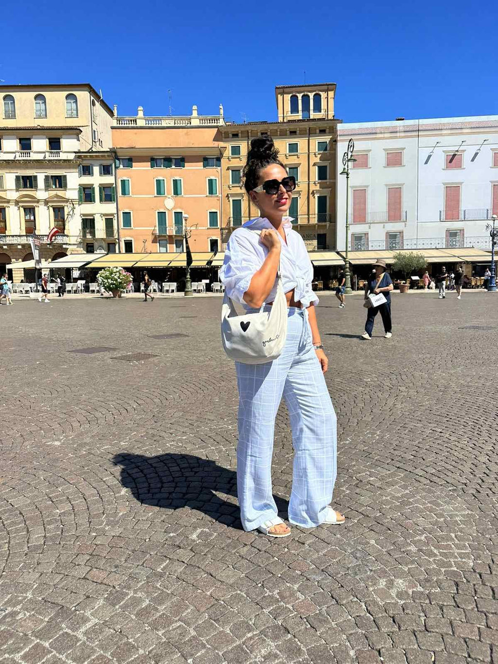 elegant white velour hobo bag with heart charm, shown in soft natural light on a marble surface