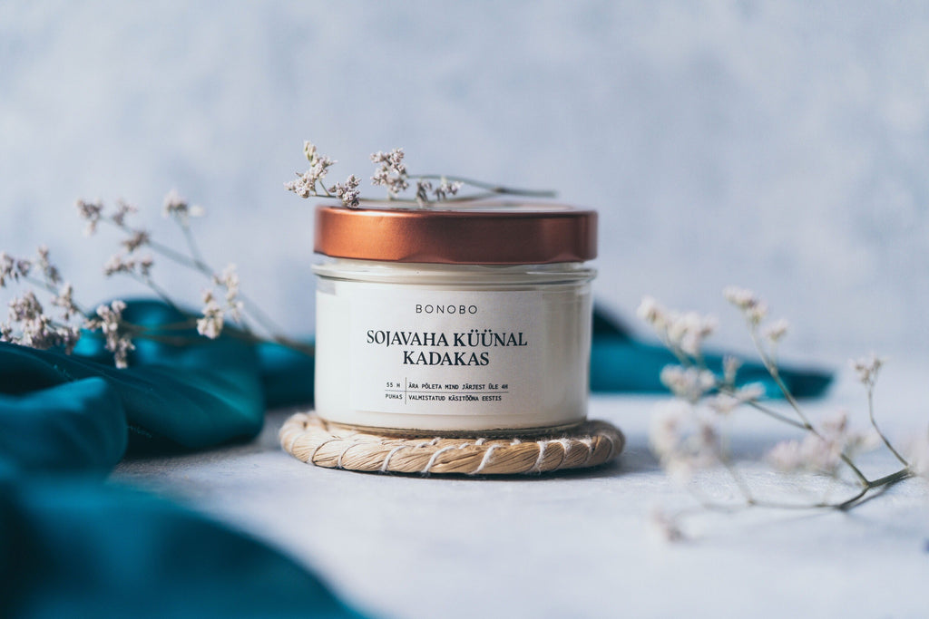 a softly lit i see you gift box with a juniper candle and orange body cream on cozy cotton