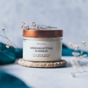 a soft cotton baby gift box with juniper candle and orange cream in warm morning light