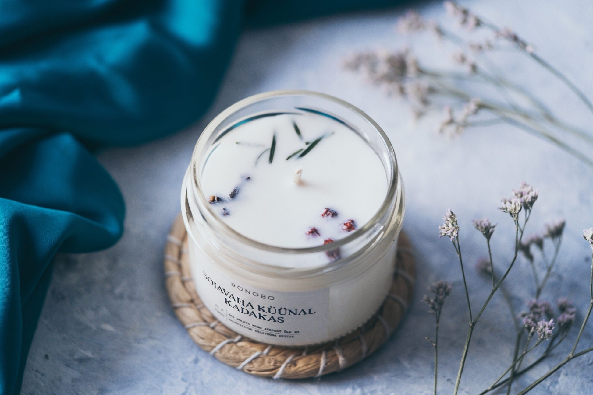a soft cotton baby gift box with juniper candle and orange cream in warm morning light