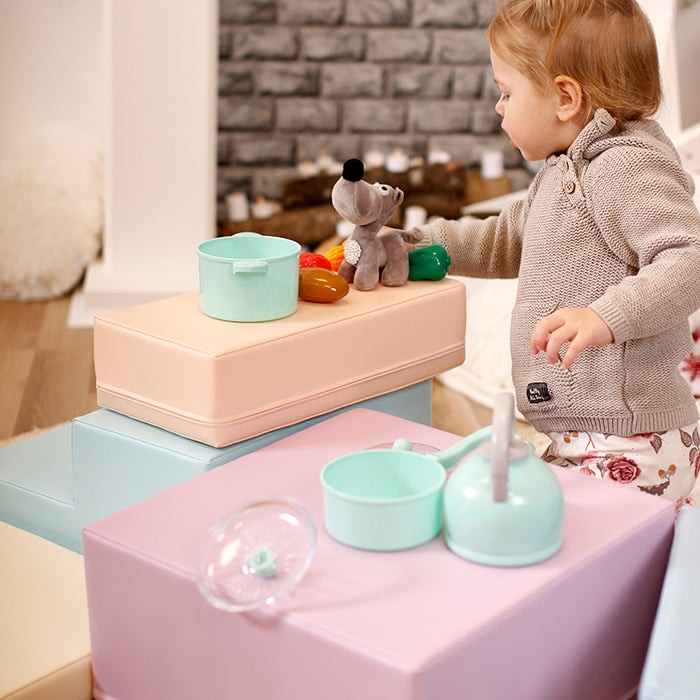 a child safely climbing the practical light pastel foam block corner climber