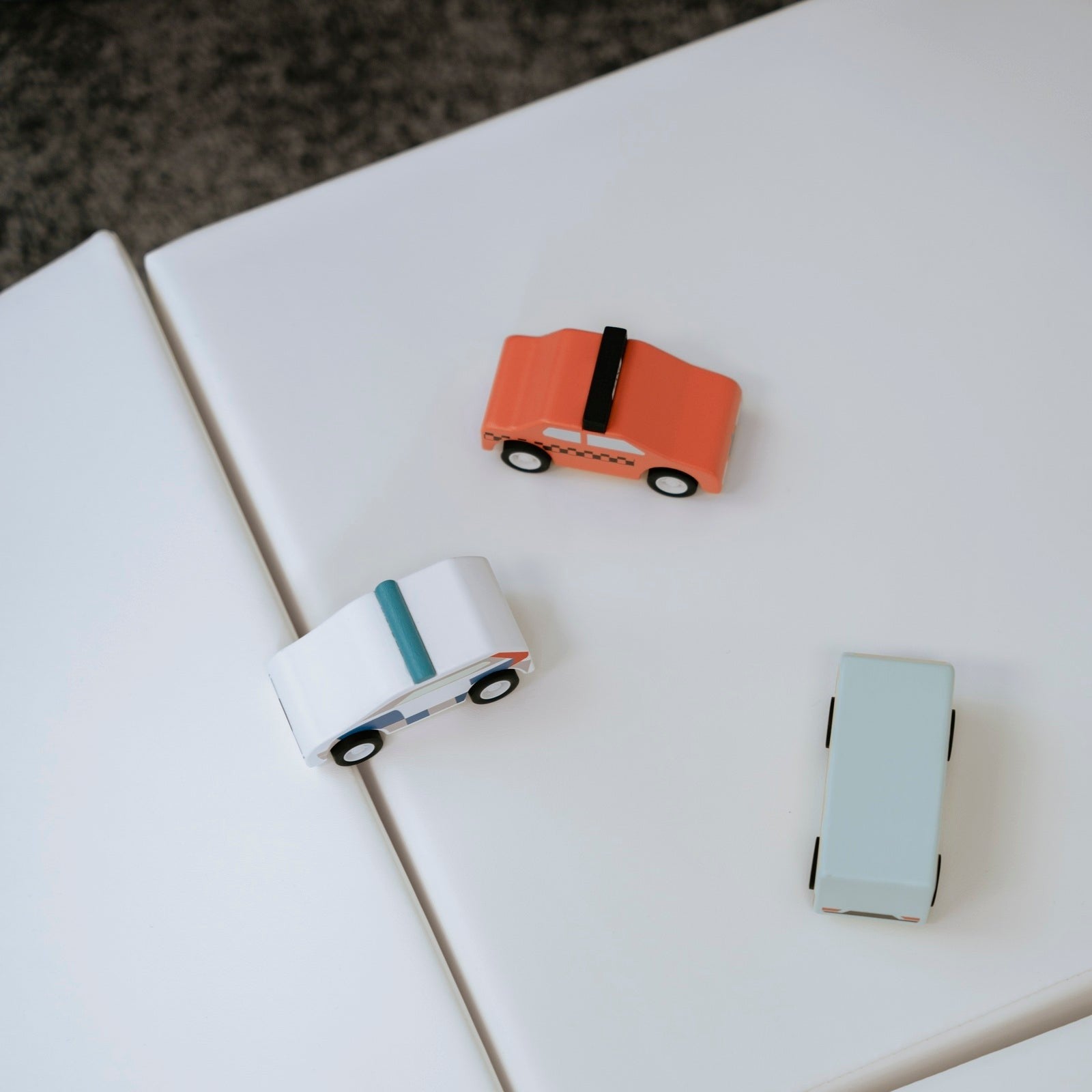 a child building a small castle with soft white foam blocks on a hardwood floor