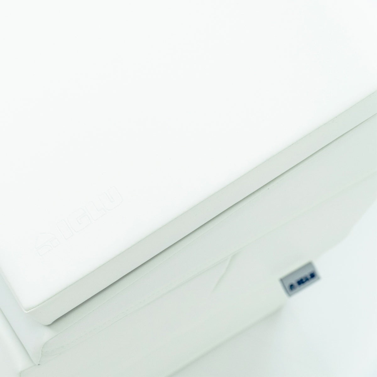 a child's hand reaching for the top of a soft white foam corner climber block