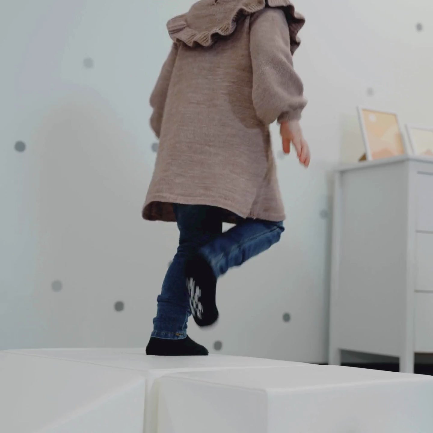 toddler climbing on a white corner climber foam block set for active play