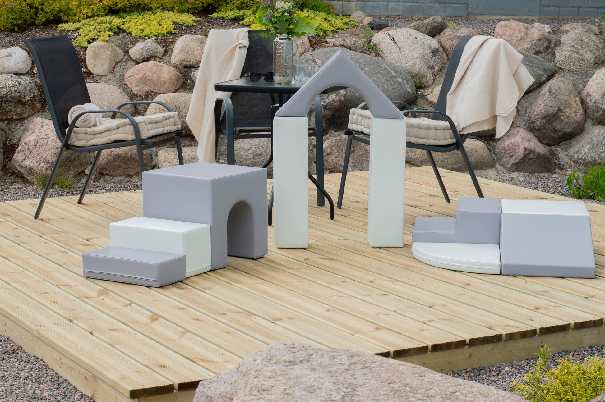 a child building a small castle with grey and white iglu foam blocks