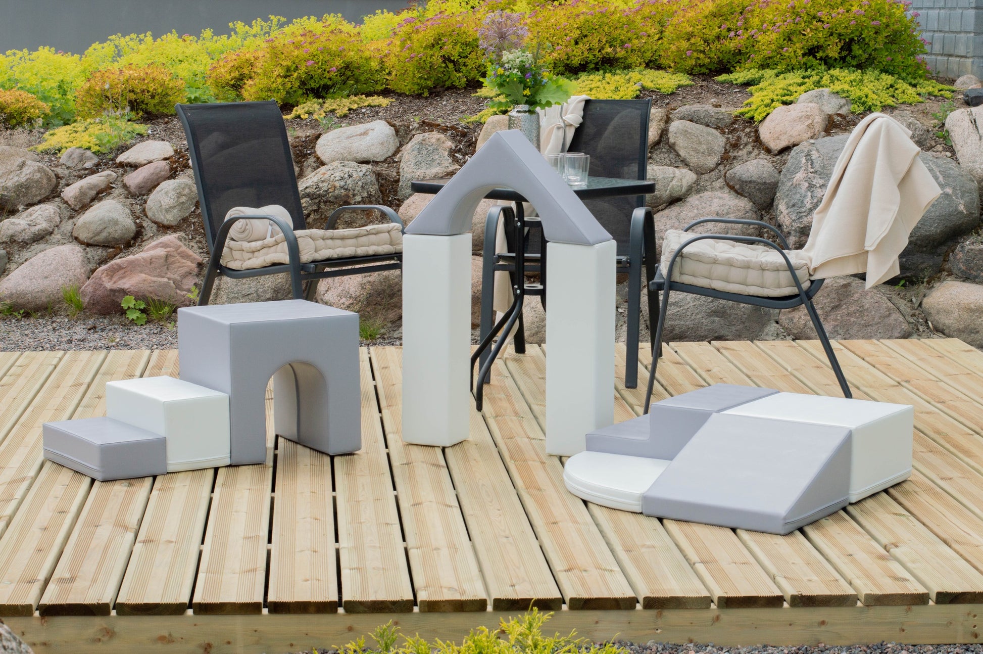 a child's hand reaching for a soft grey foam block from the iglu adventurer playset