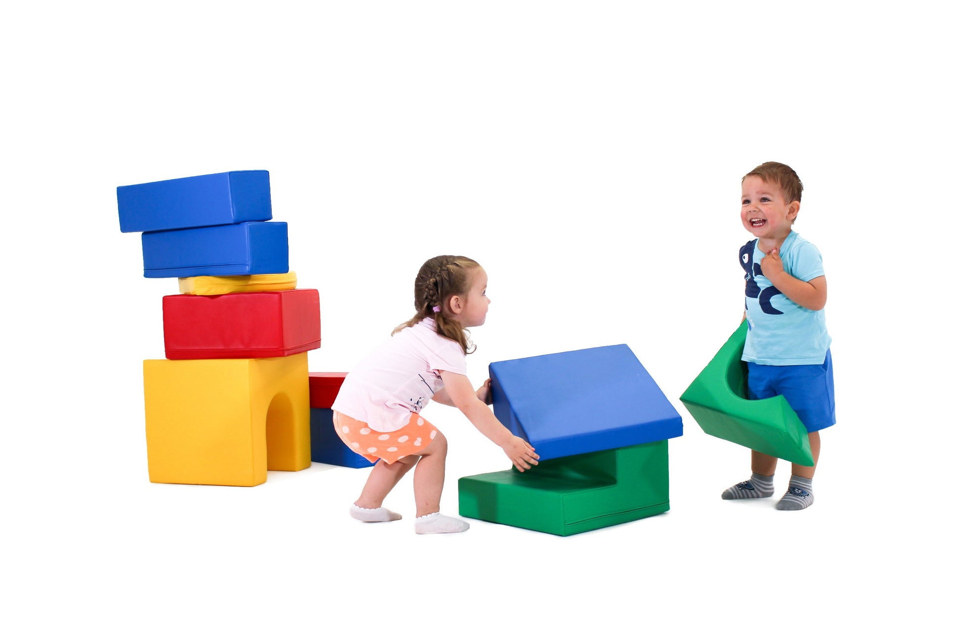 a toddler's hand reaching for a vibrant teal iglu foam block on a soft play mat