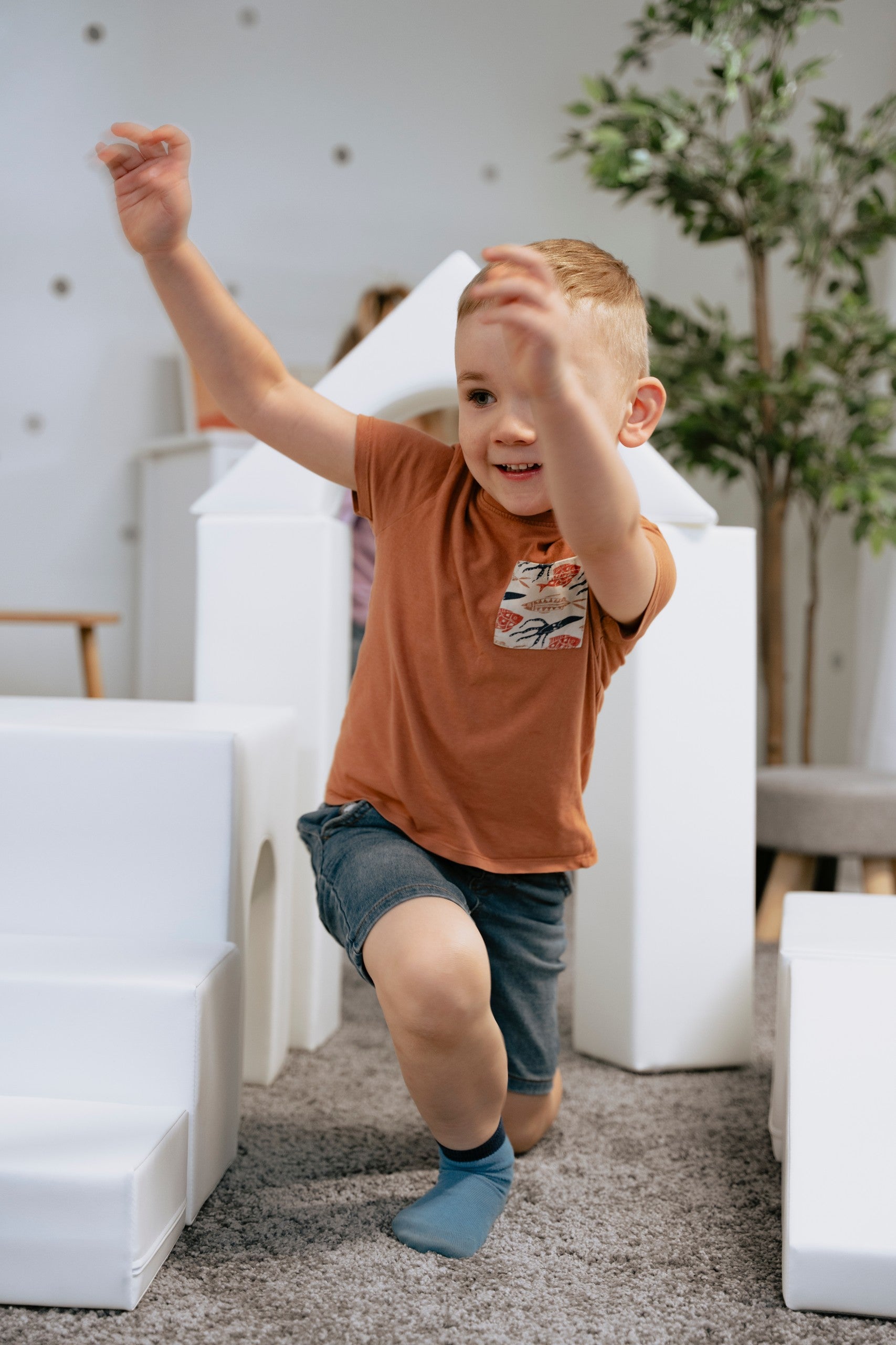 a joyful toddler building a creative castle with white iglu foam blocks