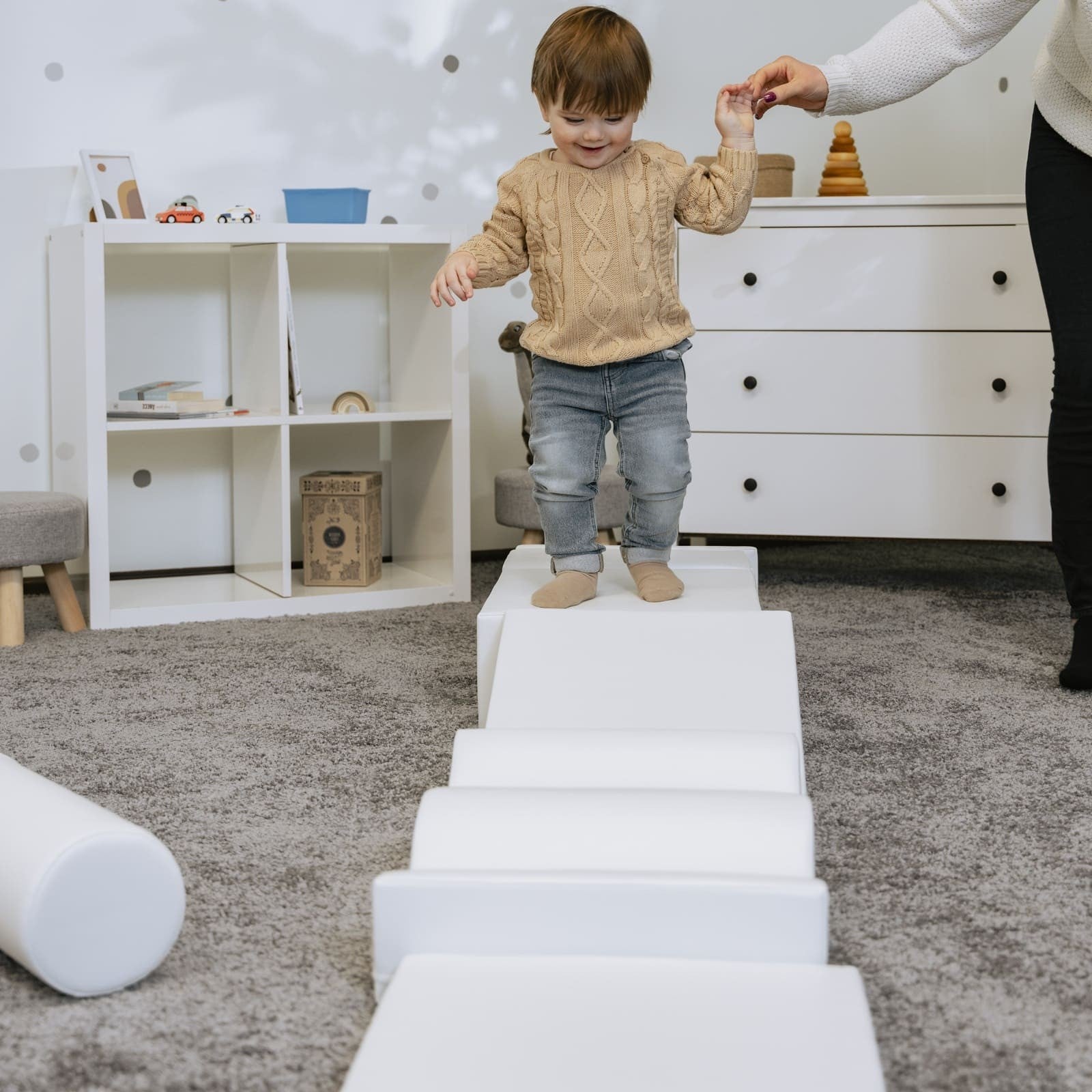 a soft white iglu foam block set arranged in a gentle, comforting nest-like formation for sensory play