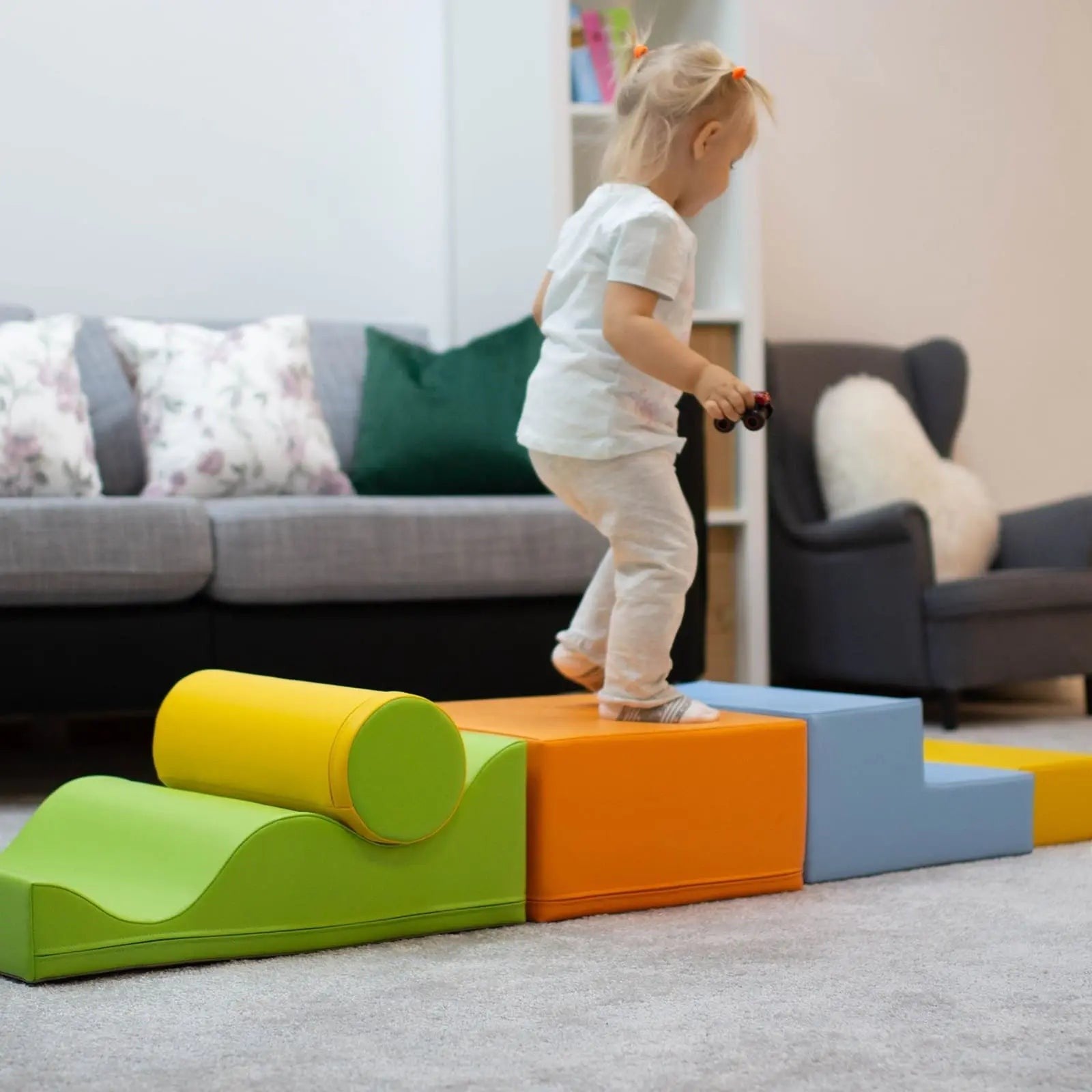 a child's hand building a vibrant iglu foam block archway in a sunlit playroom