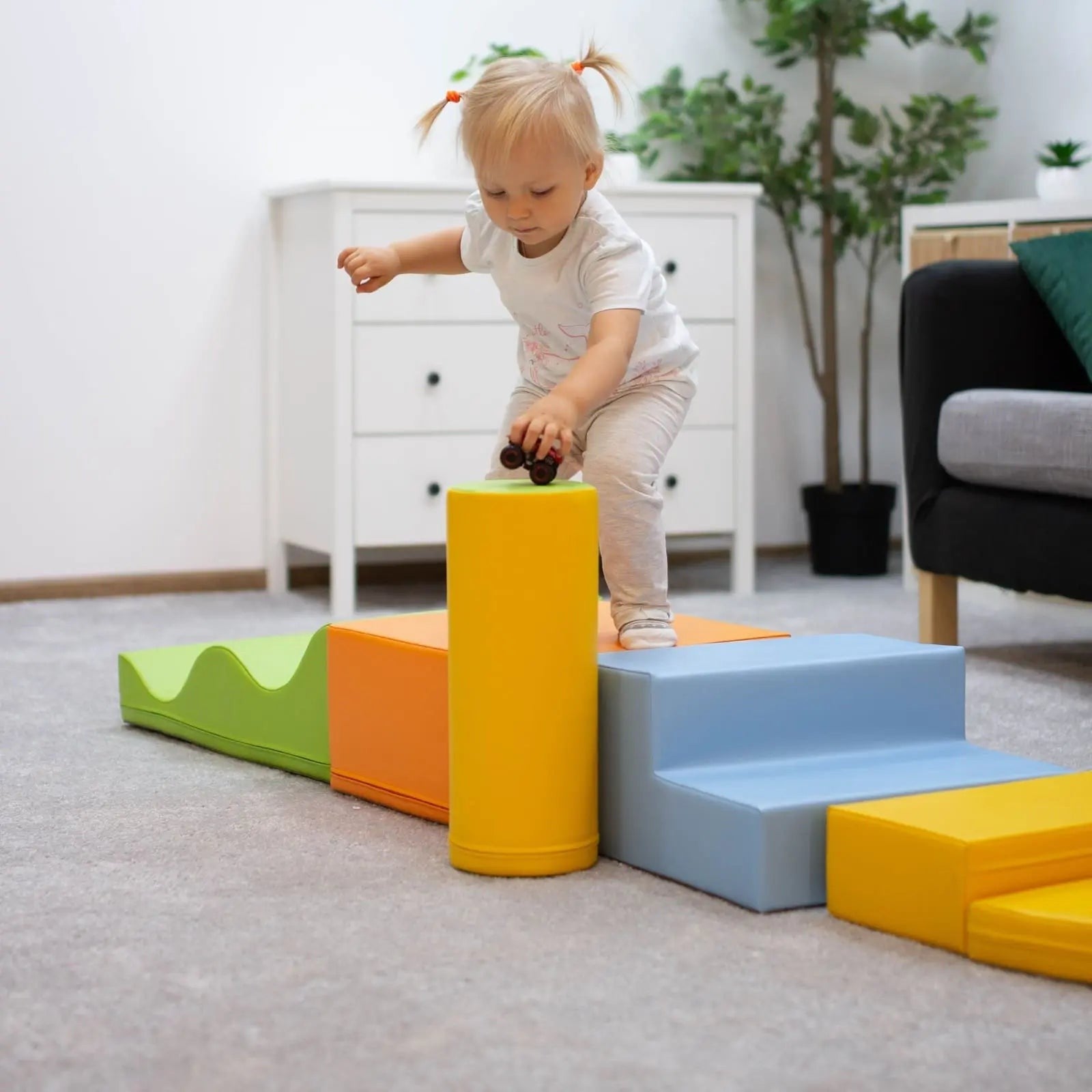 a toddler building a vibrant iglu foam block castle in a sunlit playroom