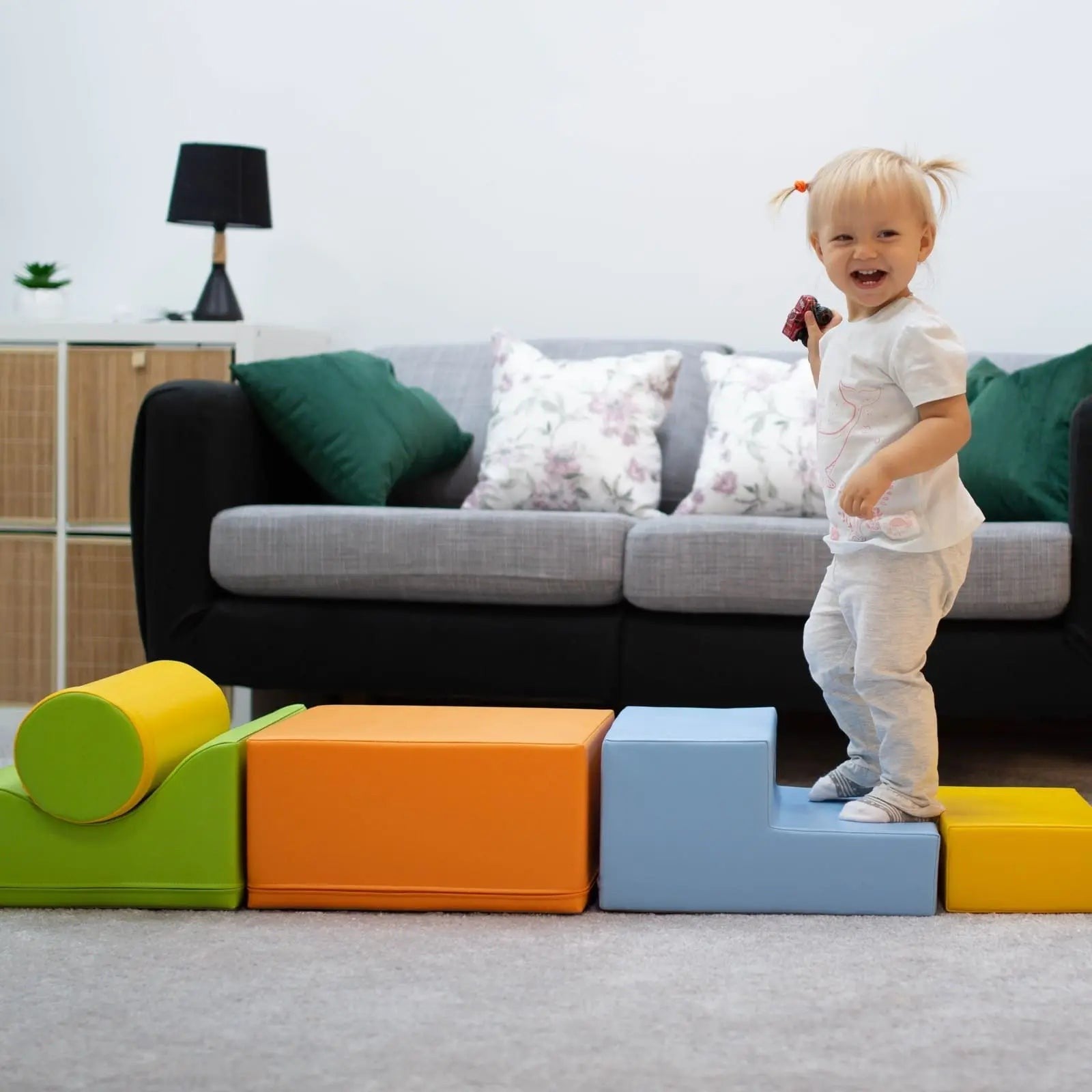 a toddler building a cozy igloo fort with soft, light-colored foam blocks