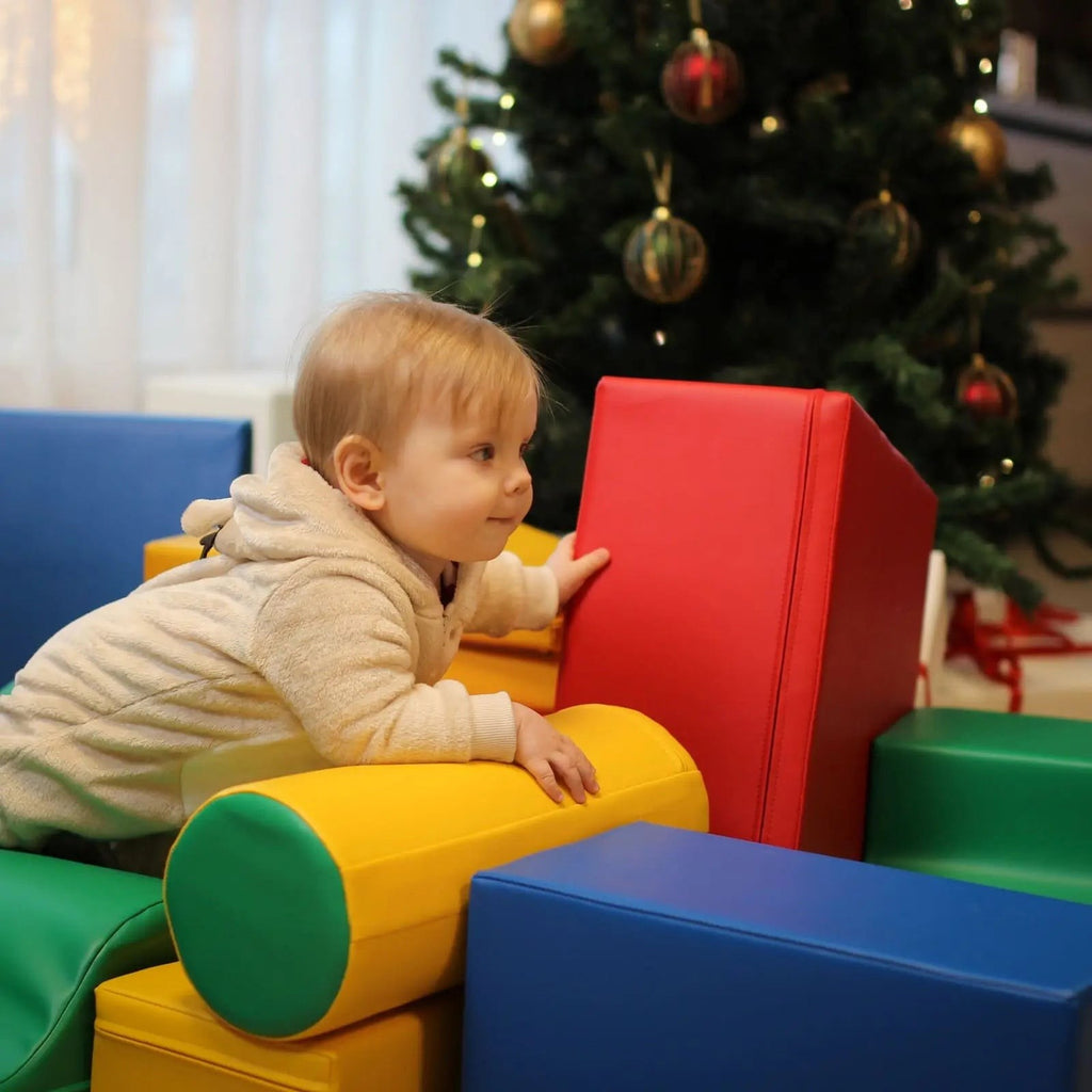 a child's hand building a vibrant iglu foam block tower in a sunlit playroom