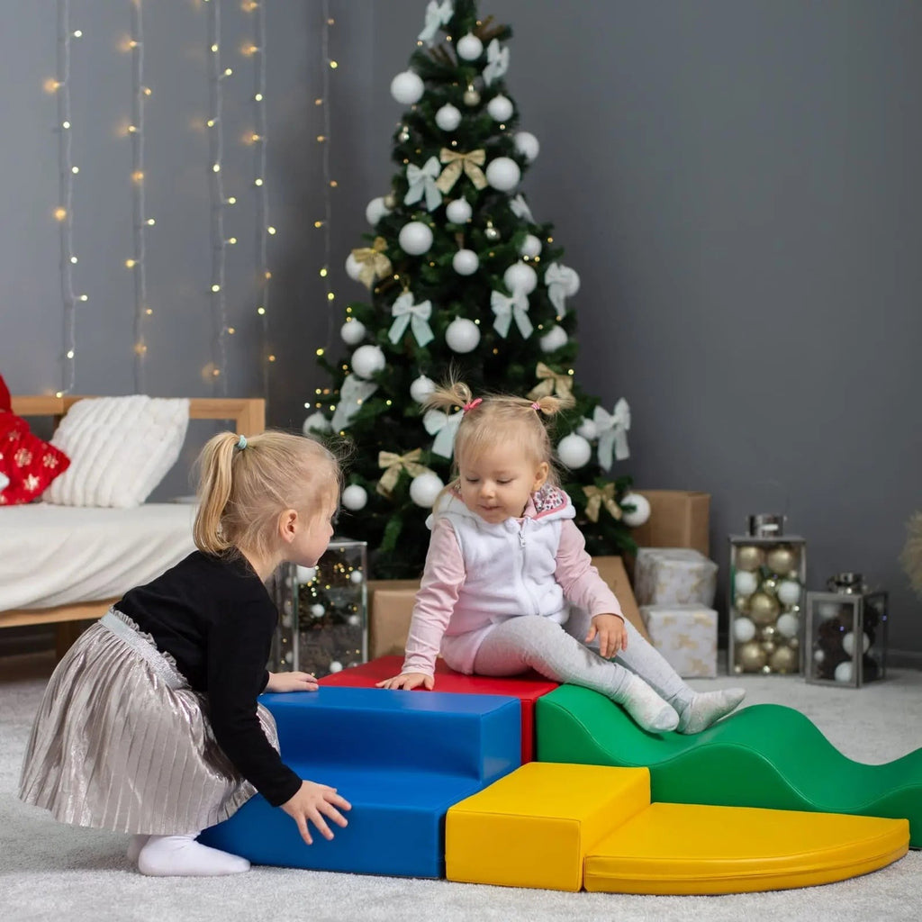 a child's hand reaching for a vibrant iglu soft foam block in a sunlit playroom