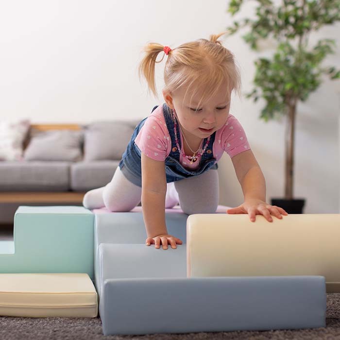 a soft pastel iglu foam block set arranged in a gentle arc, inviting calm and creative play