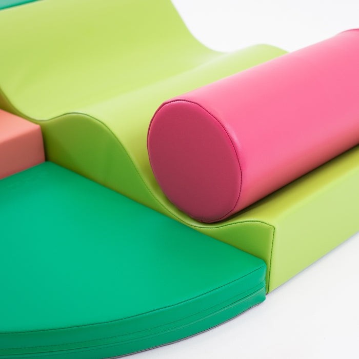 elegant arrangement of pink and green iglu foam blocks for a refined nursery play space