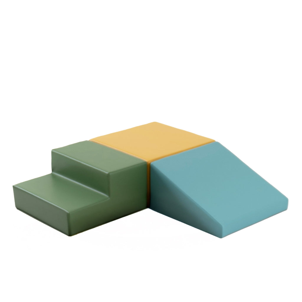 a pastel turquoise foam climbing block set arranged in a creative toddler maze on a light wood floor
