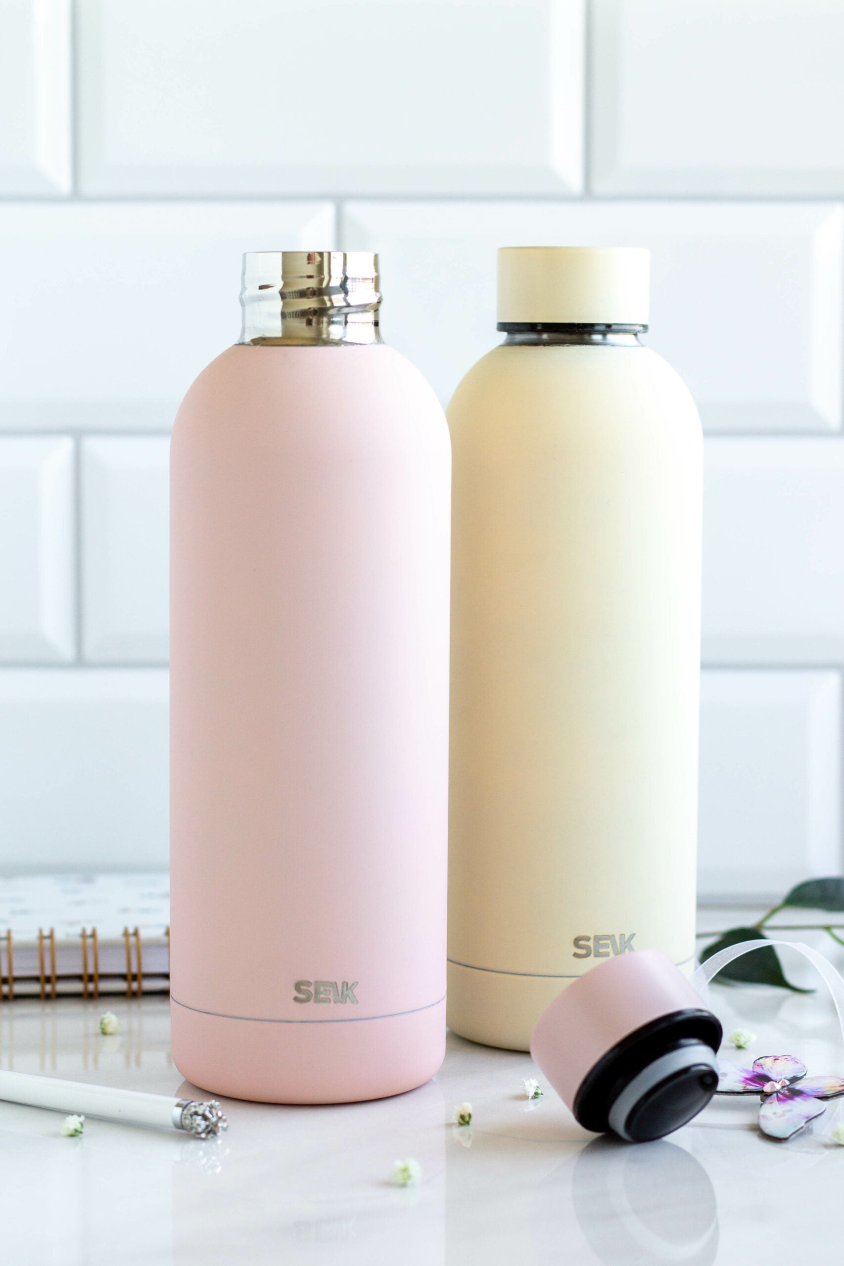 a soft pink seik thermos held in hand with gentle morning light
