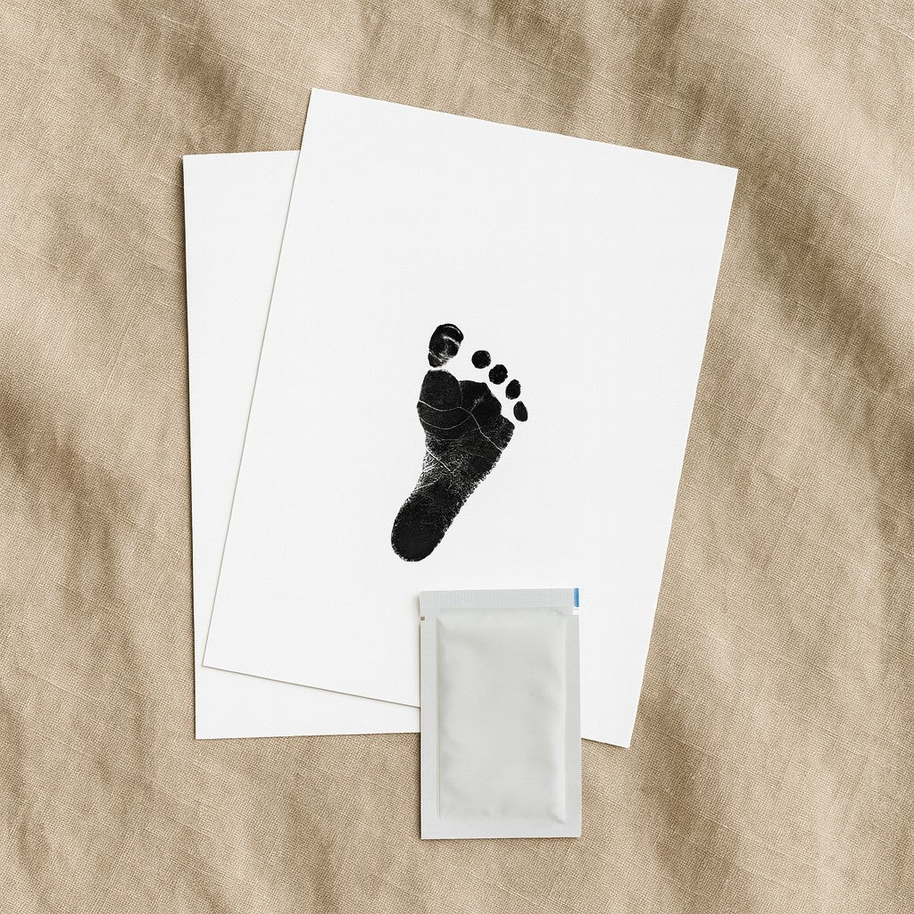 a soft-focused keepsake print of a baby's hand resting gently on a cozy cotton blanket