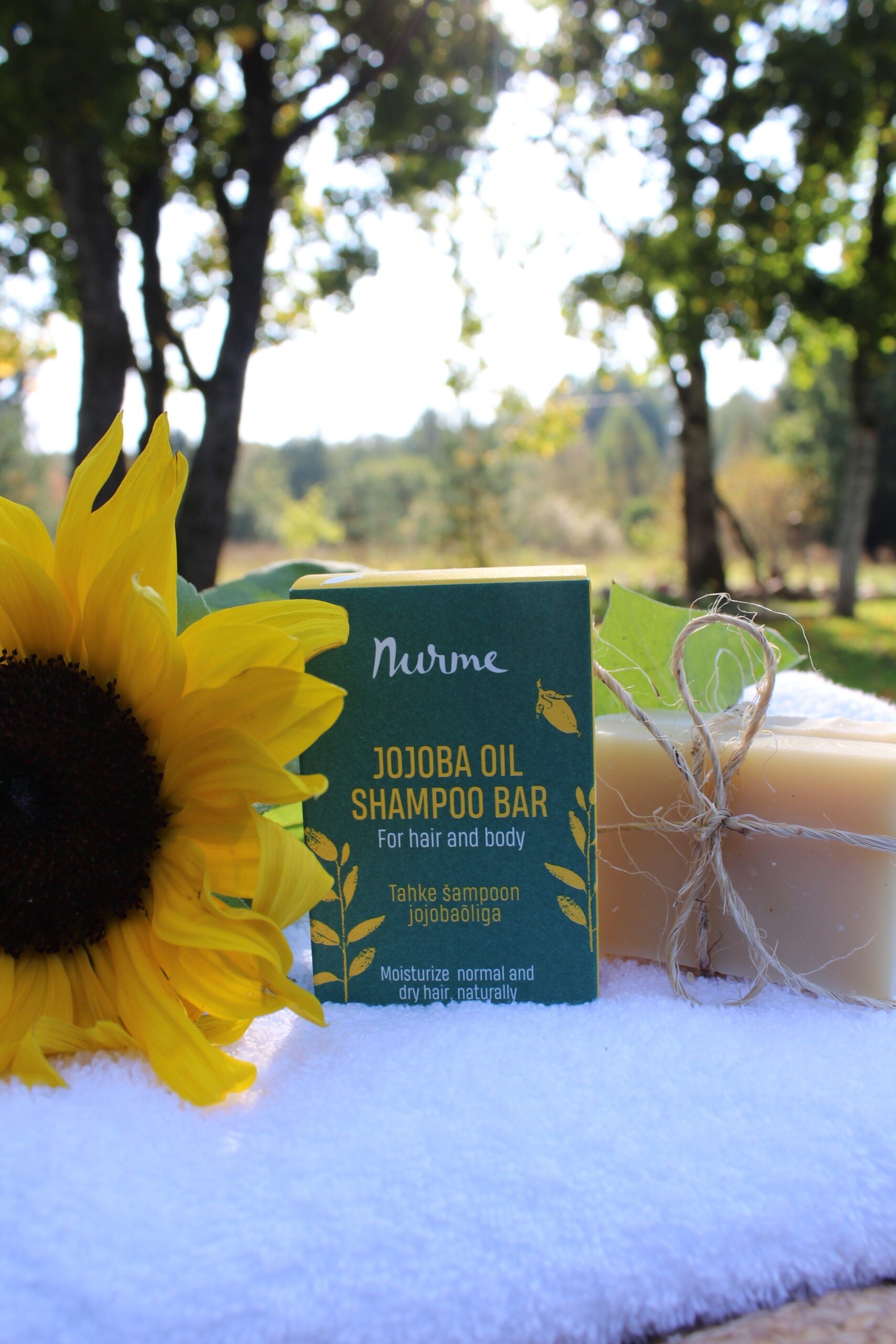 a soft-focus close-up of a nourishing jojoba oil shampoo bar resting on natural wood