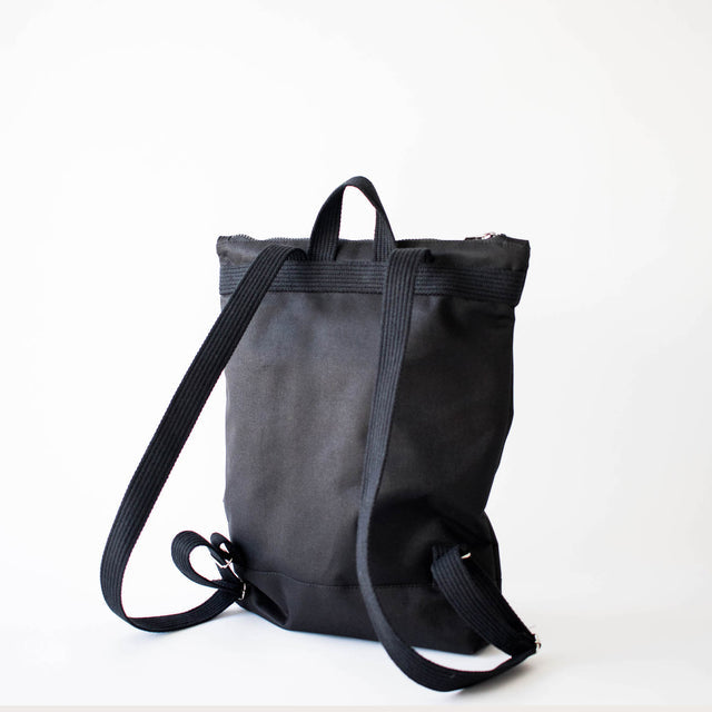 Chic Black Bow Backpack – Elegant & Weather-Resistant by Muni at www.brixbailey.com