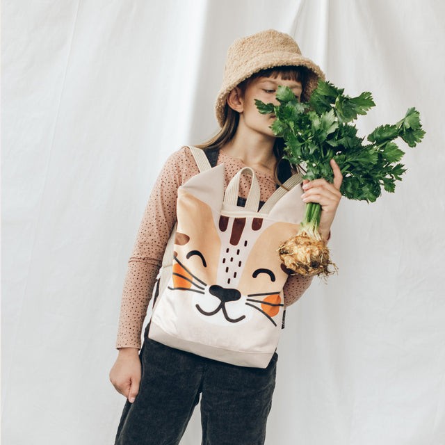 soft velvet kids cat backpack with a gentle painted design, shown in cozy morning light