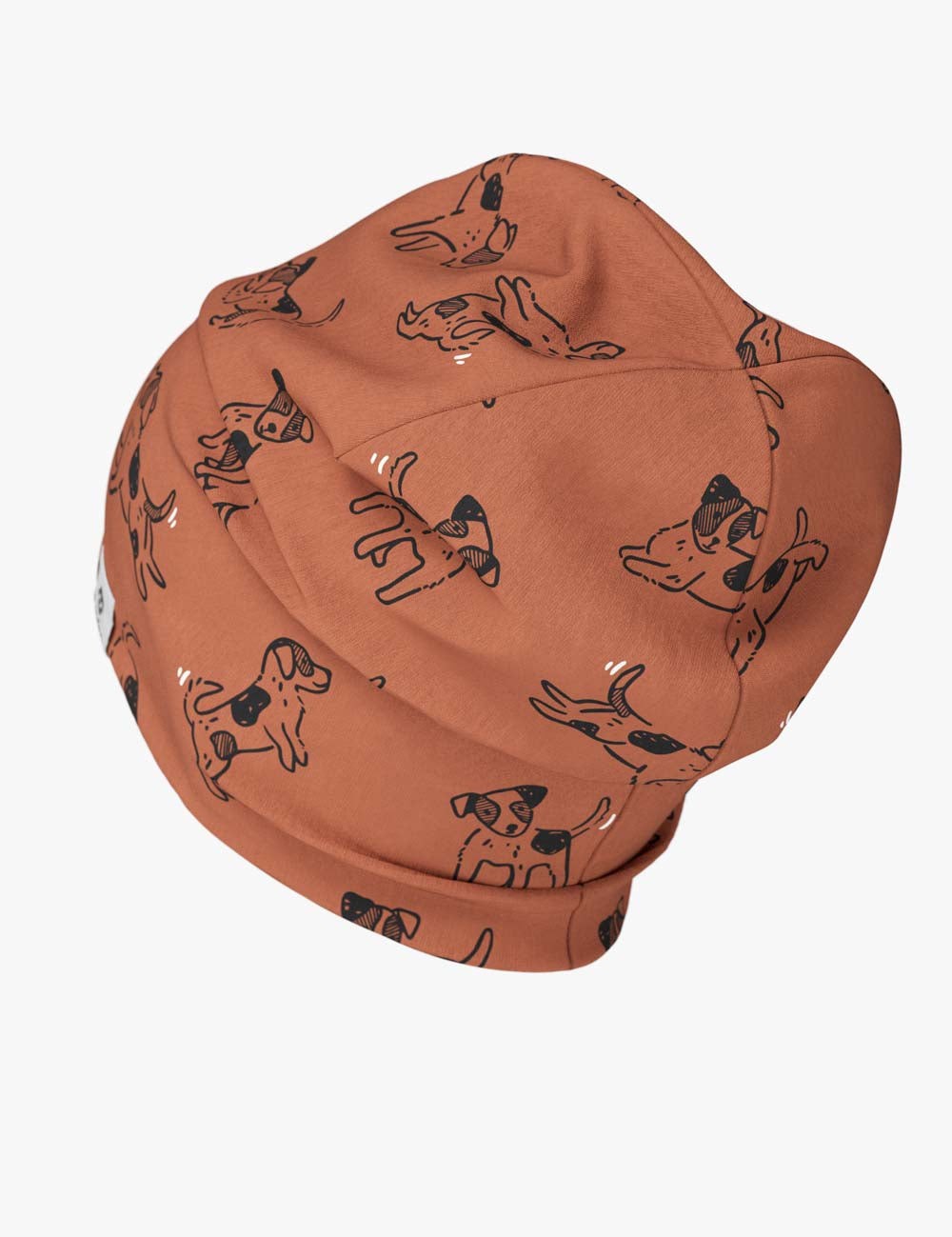 a soft kids beanie with a copper dog print, shown in gentle morning light