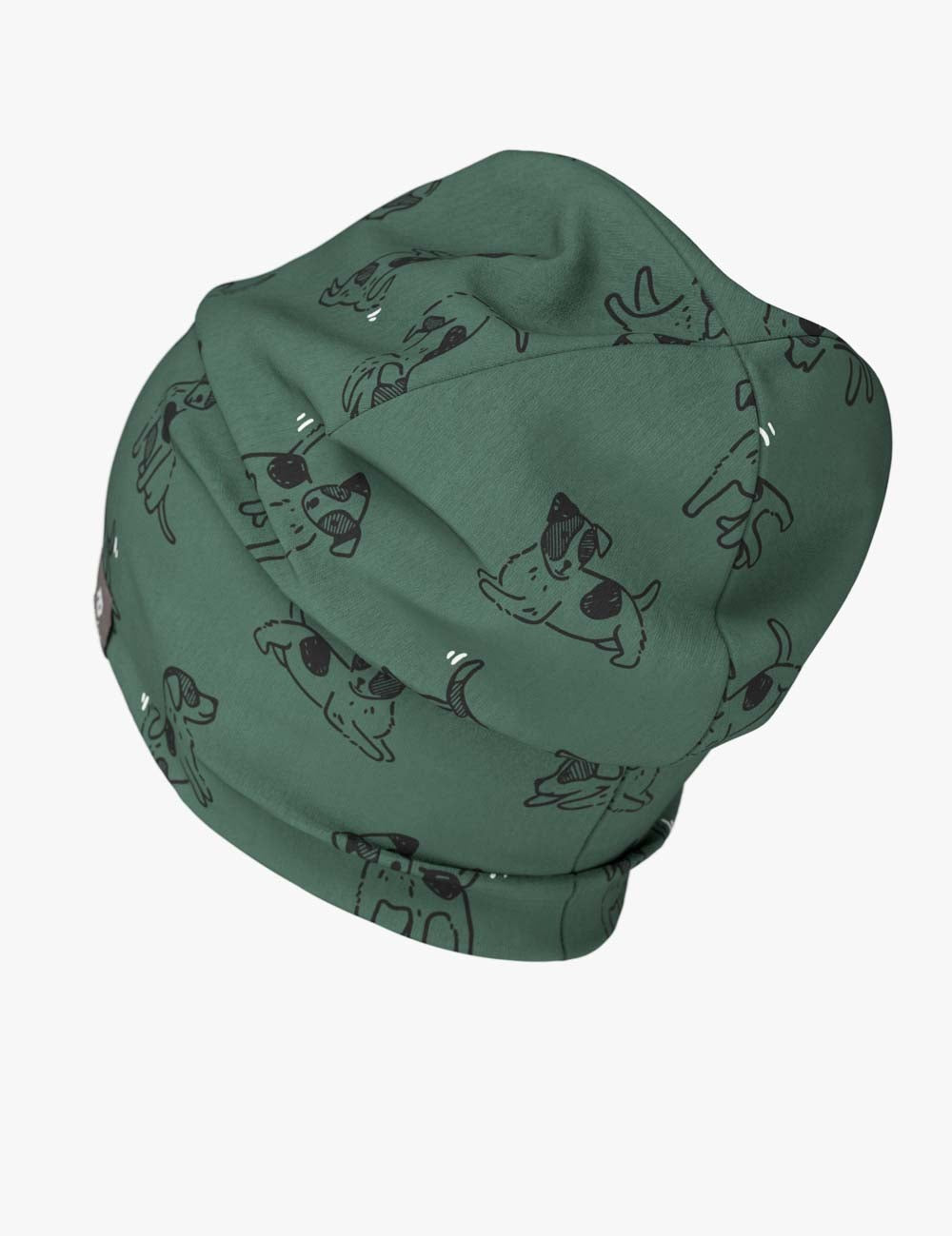 a soft green kids beanie with a playful dog print, shown in gentle morning light
