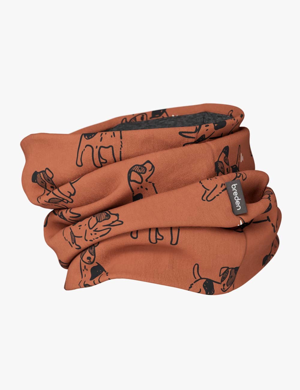 bold kids merino neck tube in warm copper dogs print, close-up on a textured leather bag