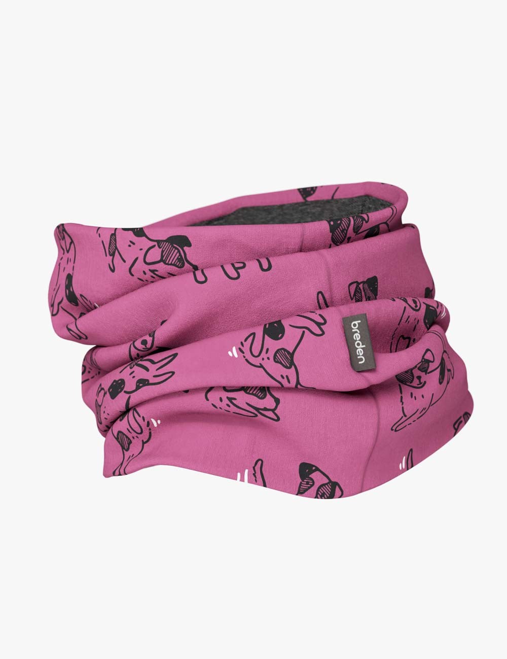 a child's pink merino neck tube with a playful dog pattern, shown in soft morning light