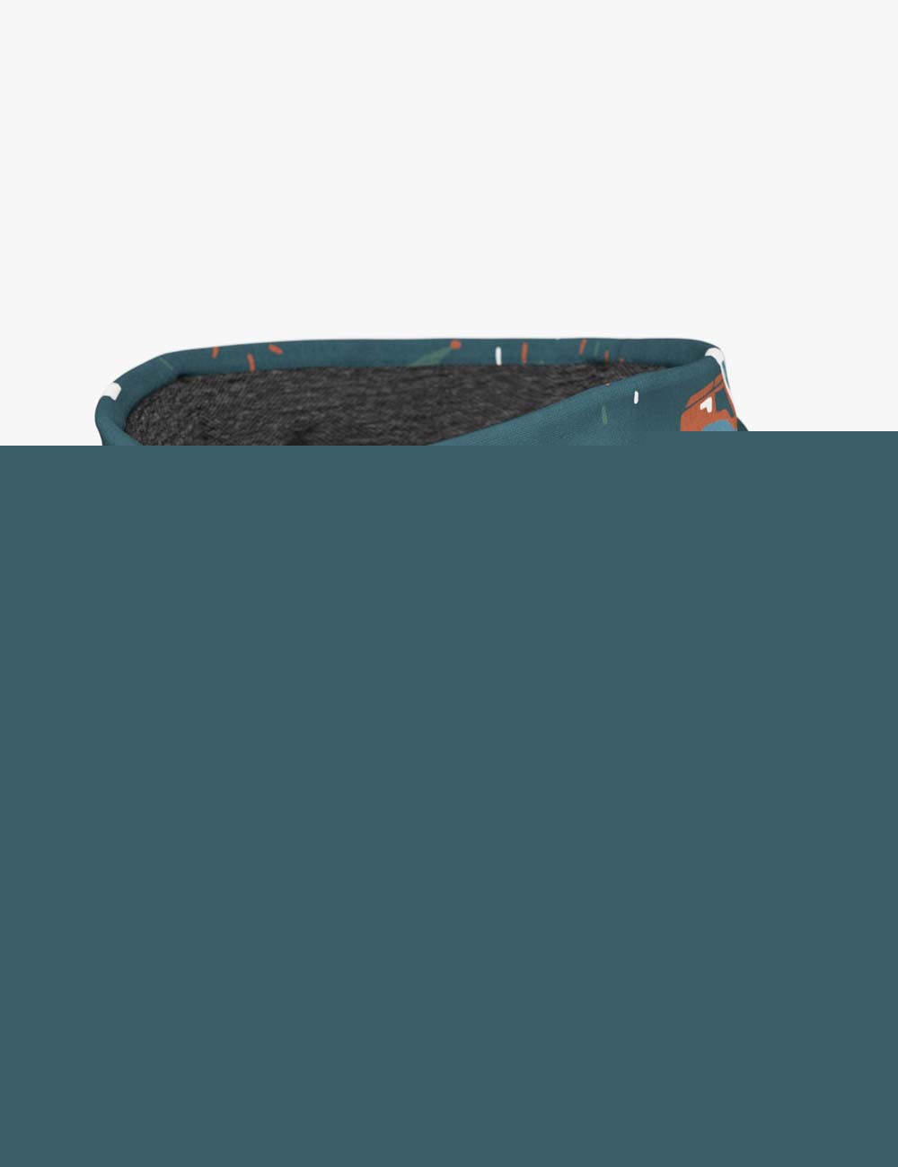 a child giggling while wearing a cozy tractor-print neck tube on a sunny farm adventure