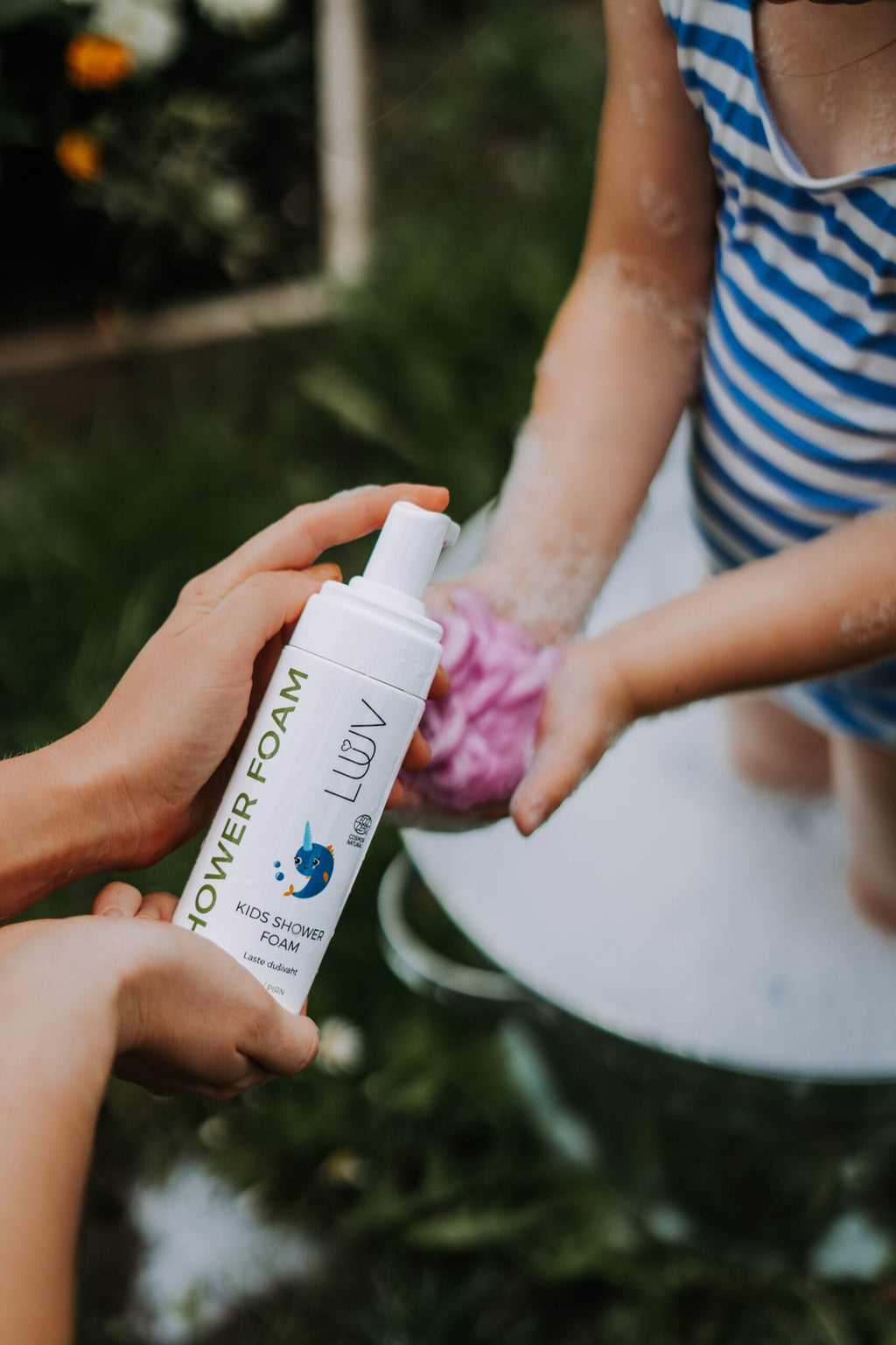 close-up of luuv pear shower foam bottle showing eco-certified label and practical pump