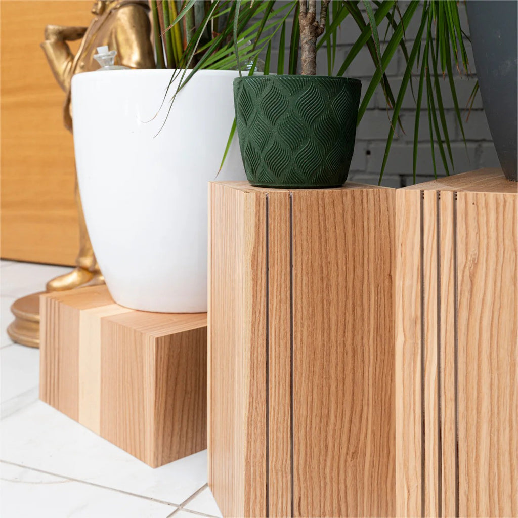 elegant set of three latvian-crafted wooden cube plant stands in a refined minimalist interior