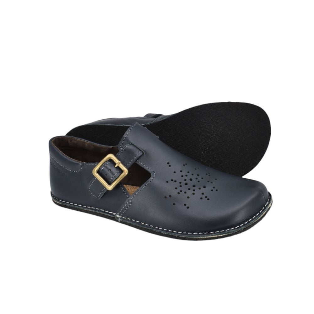 kuuda dark blue leather shoe with adjustable buckle strap, shown from a functional side angle on a natural wood surface