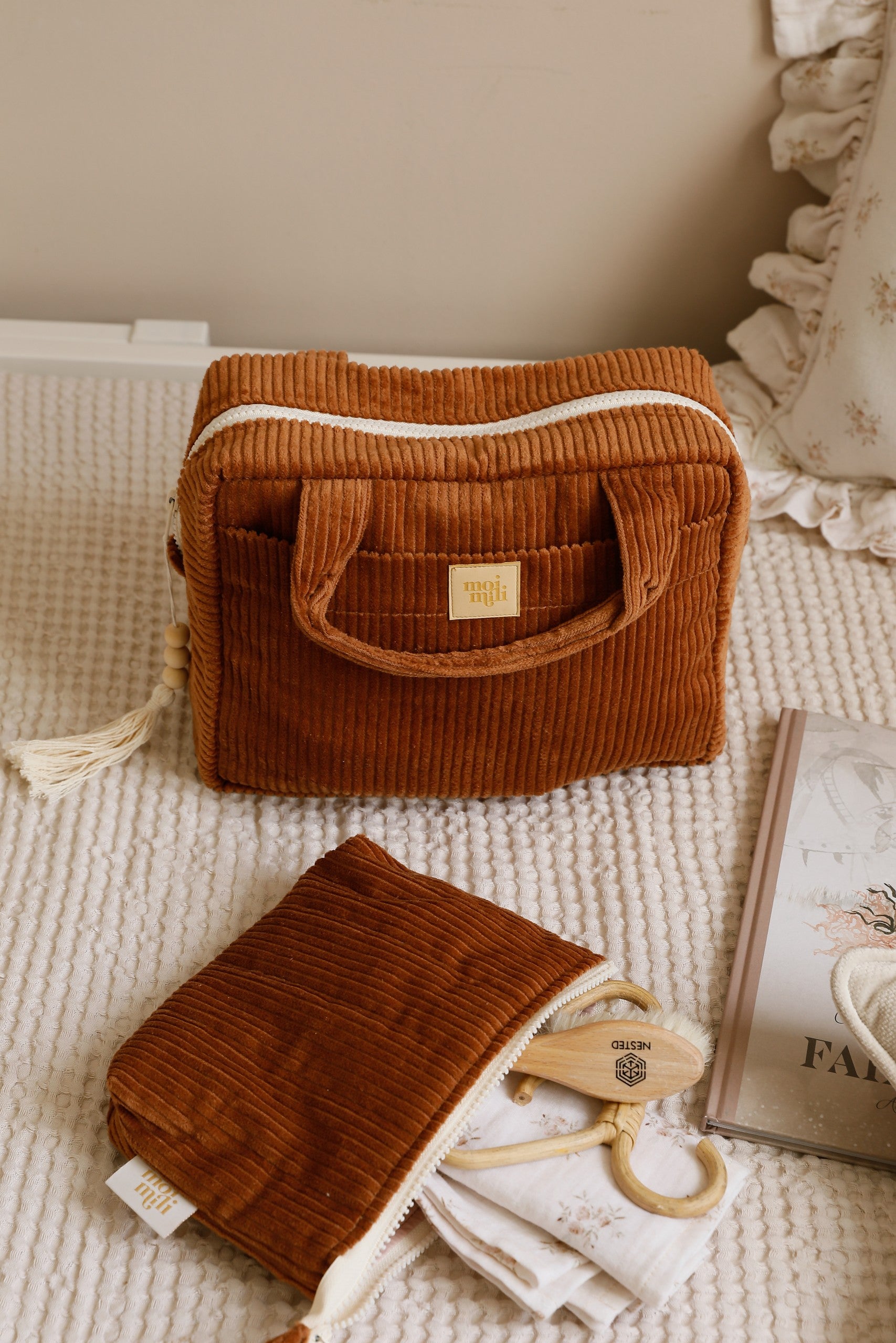 bold caramel makeup bag open on a rustic table showcasing its waterproof lining and inner pocket