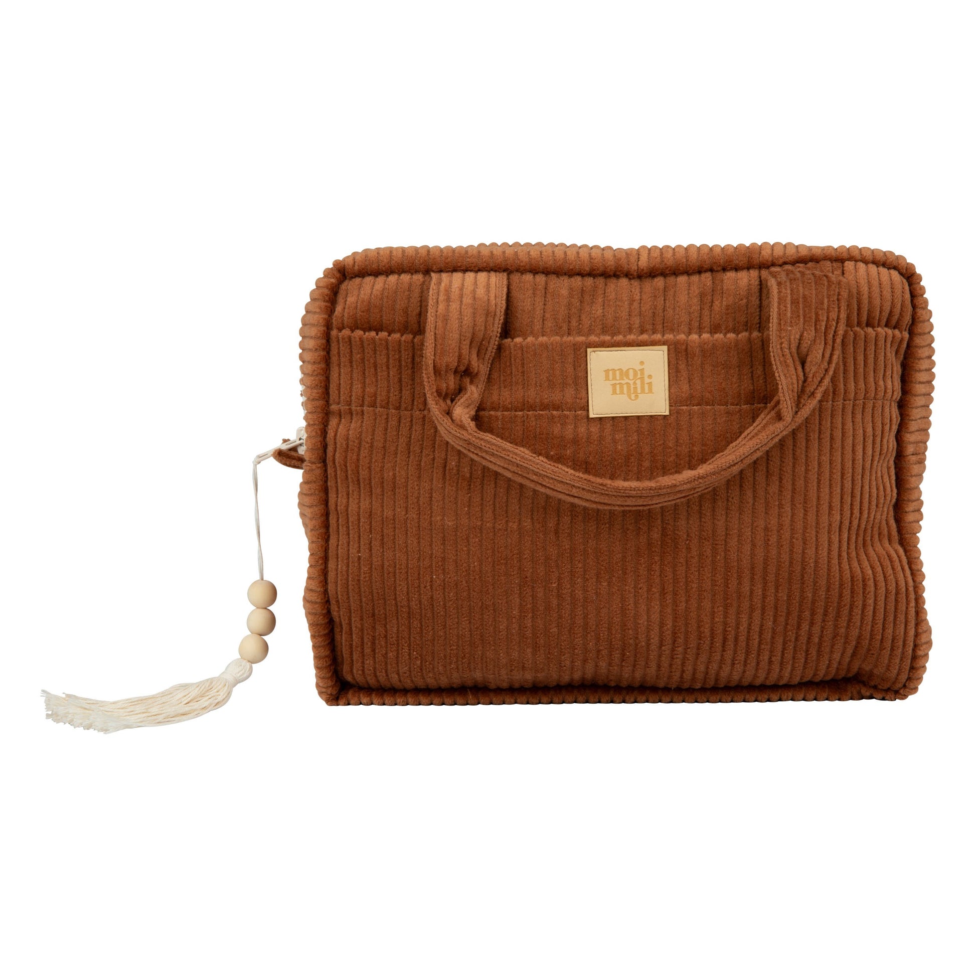 playful caramel makeup bag with outer pocket open on a sunny picnic blanket