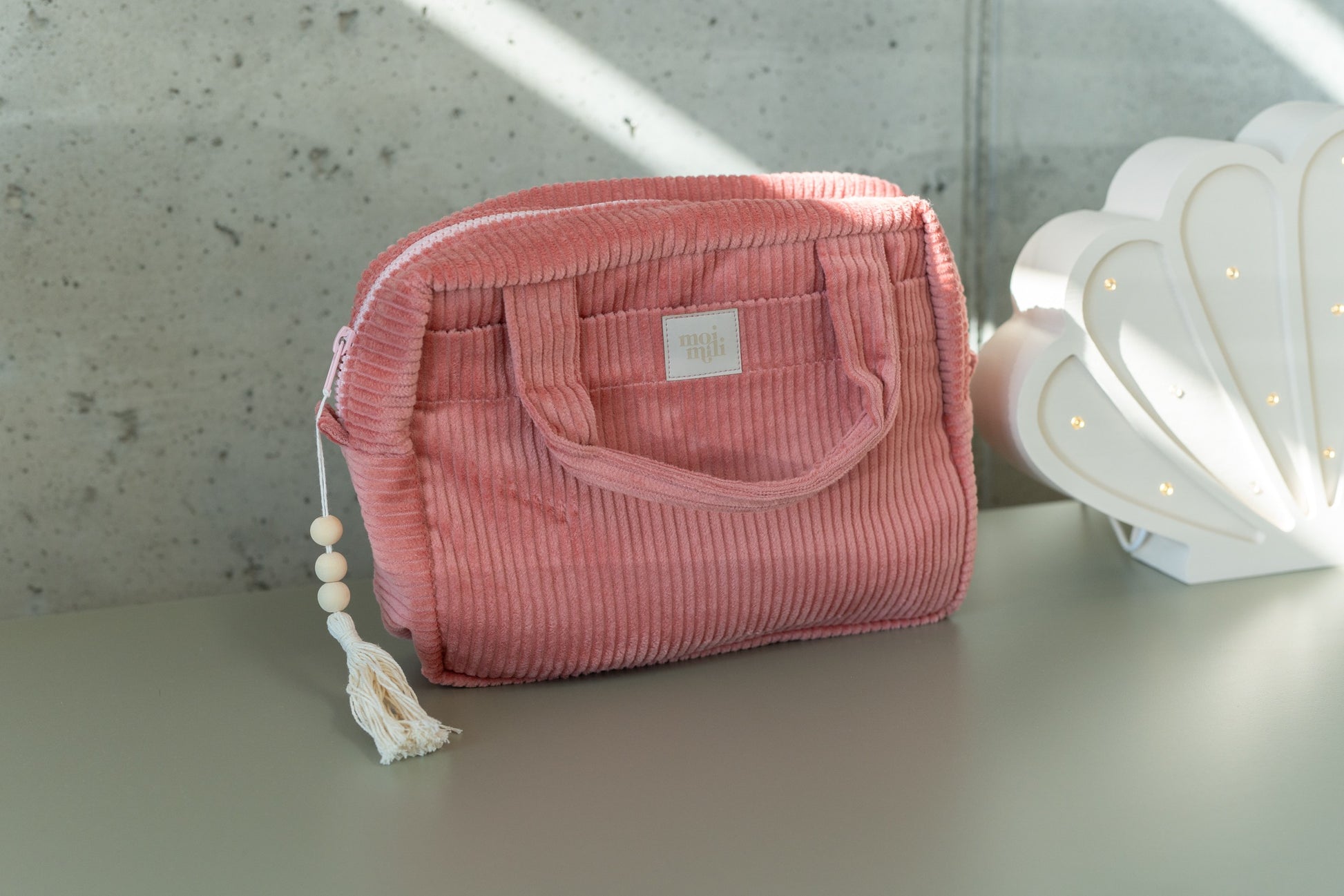 soft coral cotton makeup bag with a gentle glow, open to show its spacious and comforting interior