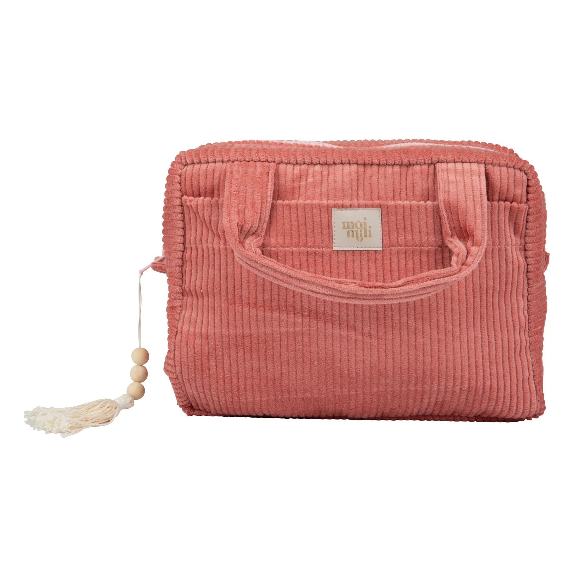 handmade coral cotton makeup bag open on a sandy beach, showing its spacious interior and pockets