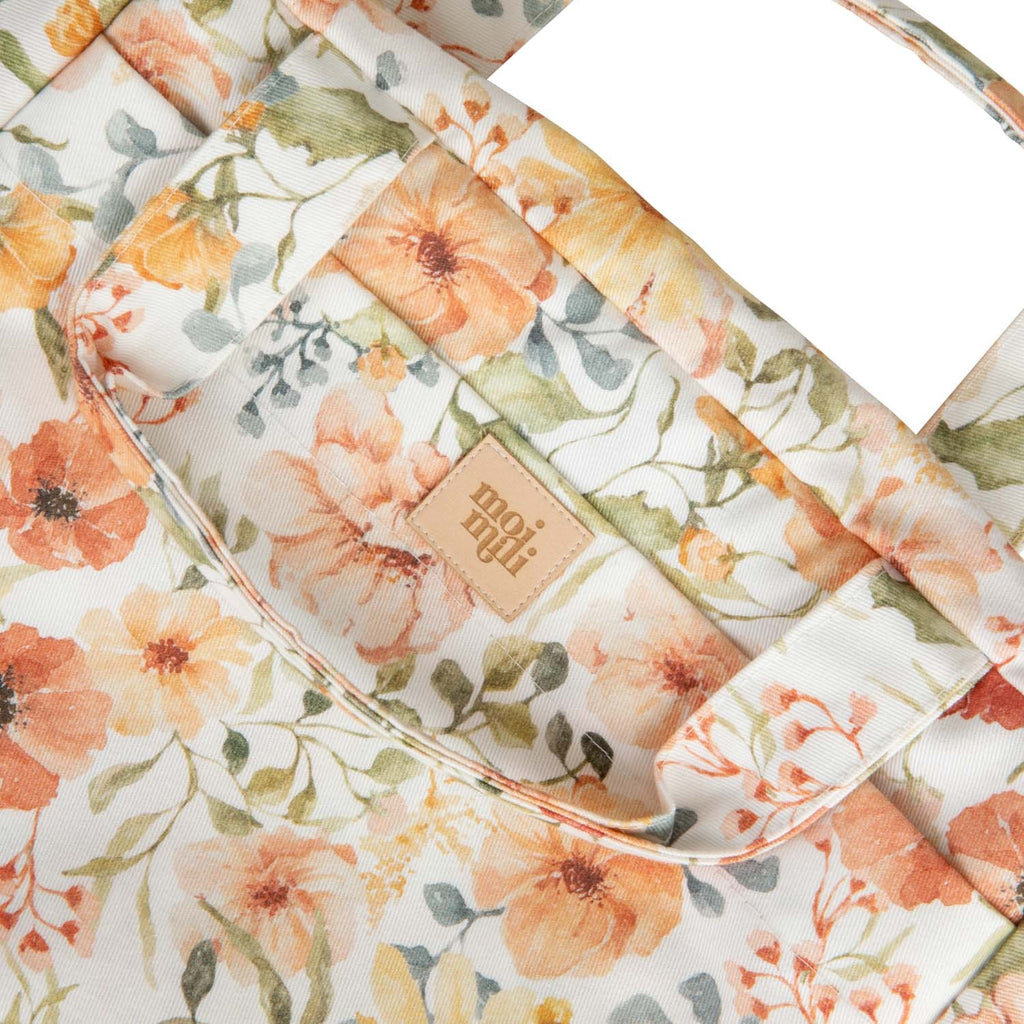 playful cotton makeup bag with a vibrant floral print, open to show its inner pocket