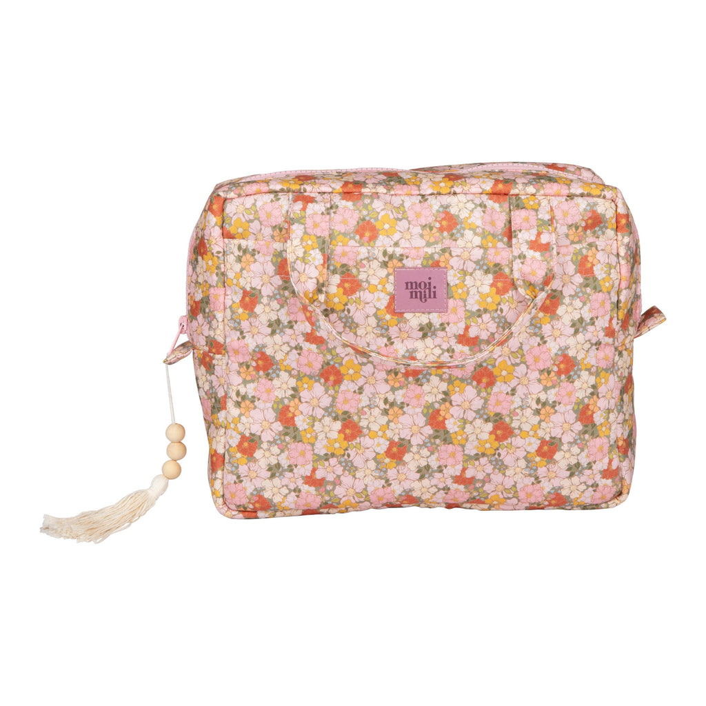 elegant green garden makeup bag set displayed on a marble surface with soft side lighting