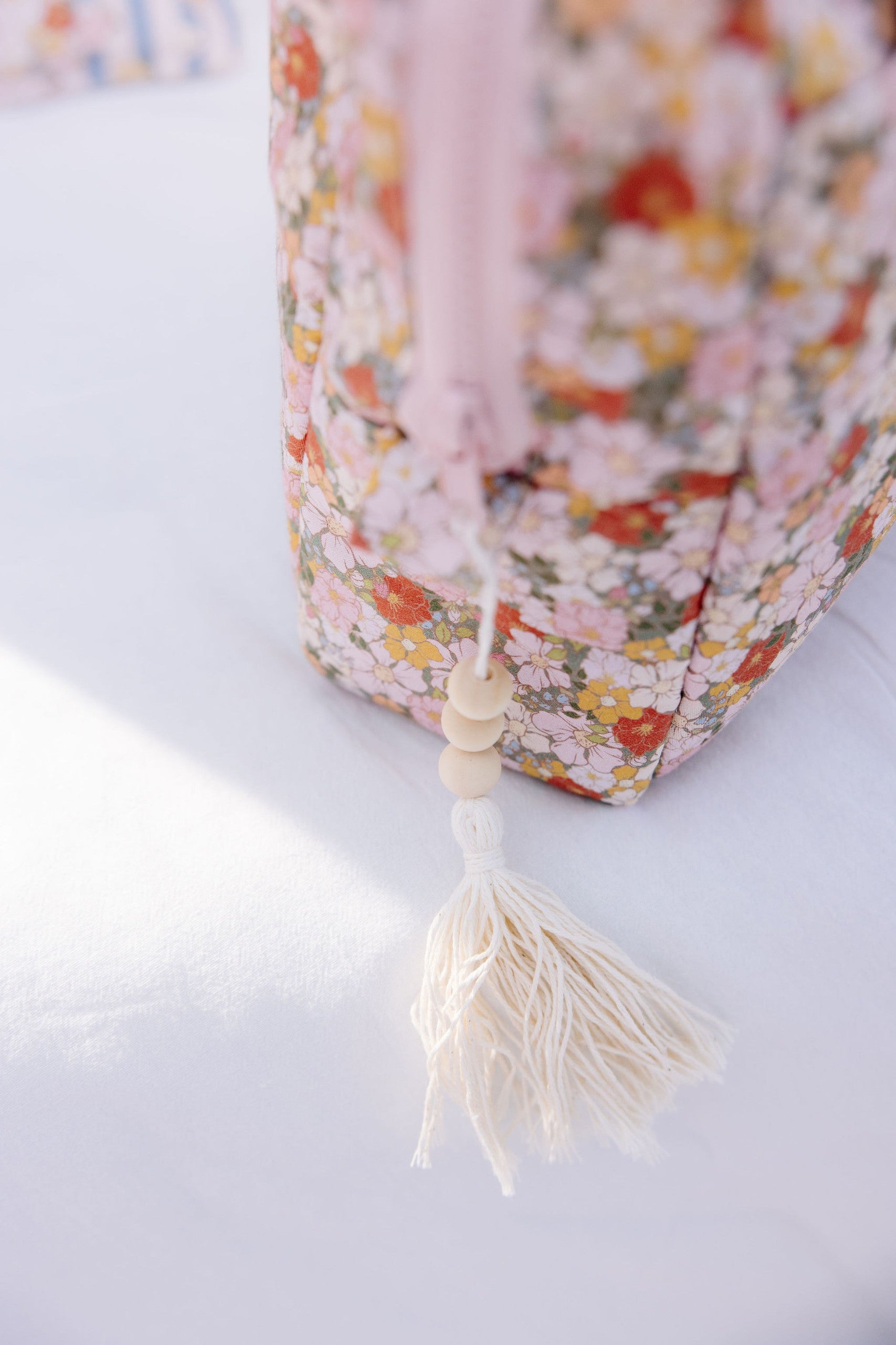 green garden makeup bag with waterproof lining and pockets, laid on a rustic wooden table with soft sunlight