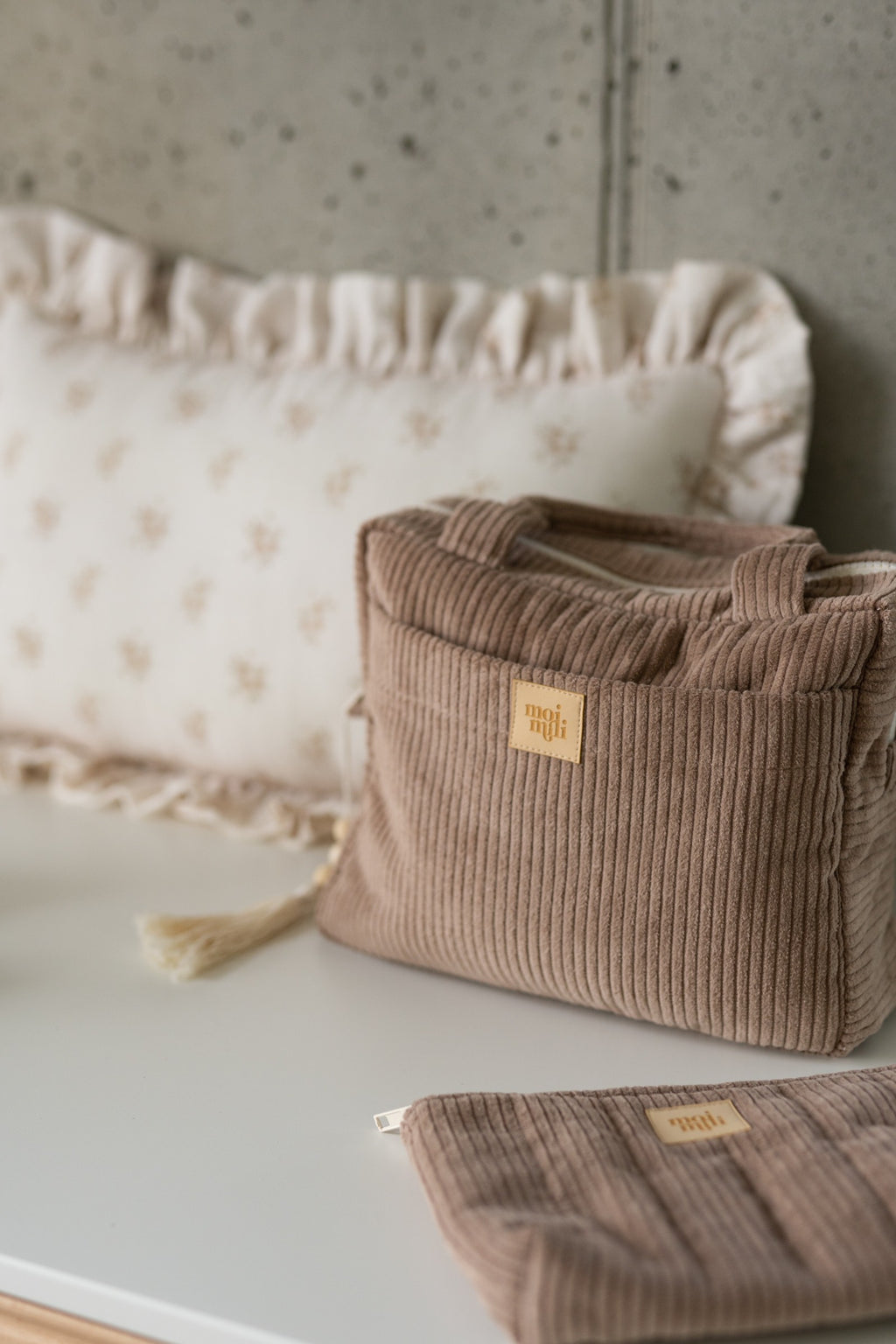 elegant latte-colored makeup bag with minimalist design, open to show spacious interior and waterproof lining