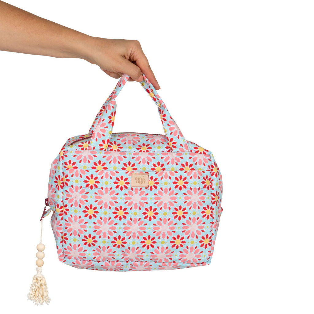 bold red floral makeup bag with waterproof lining, open to show spacious interior and pockets