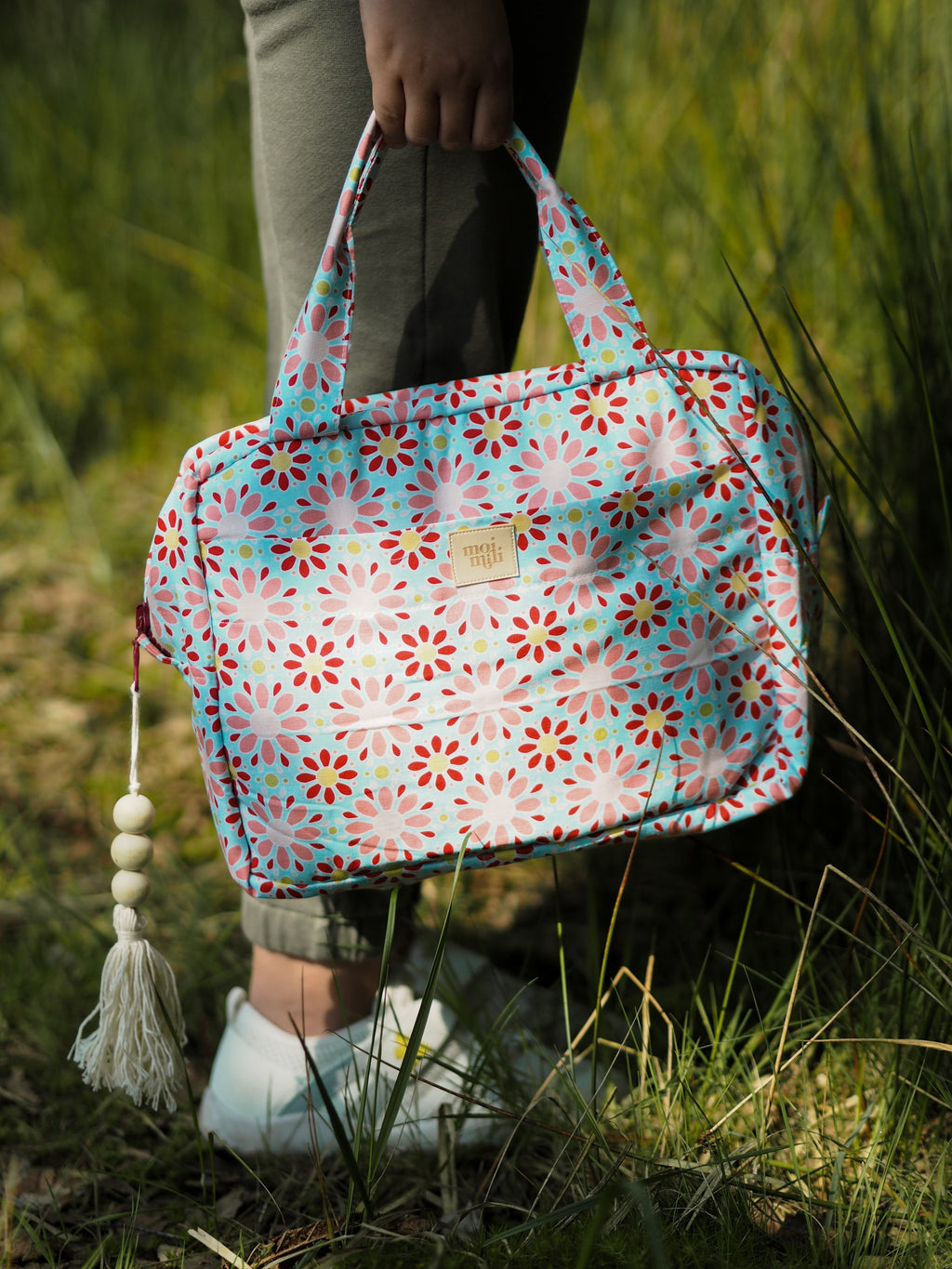 playful red floral makeup bag set open on a sunny windowsill