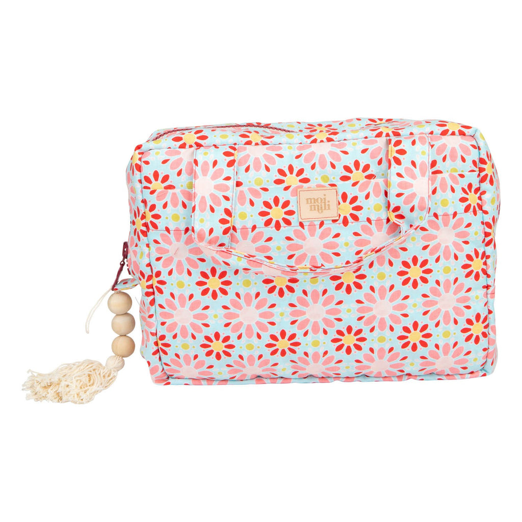 functional red floral makeup bag set open on a table showing its waterproof lining and interior pockets